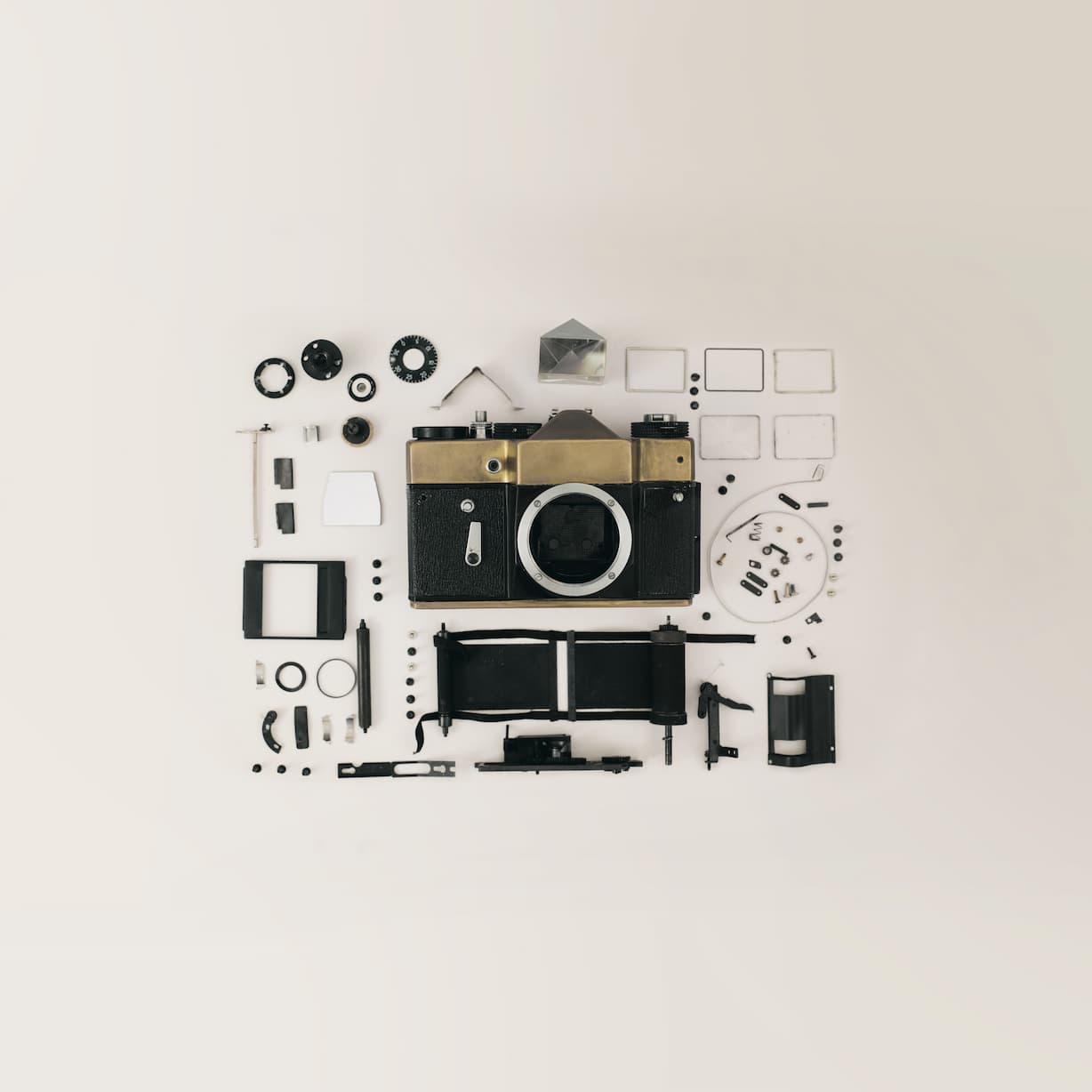 Disassembled camera on flat background