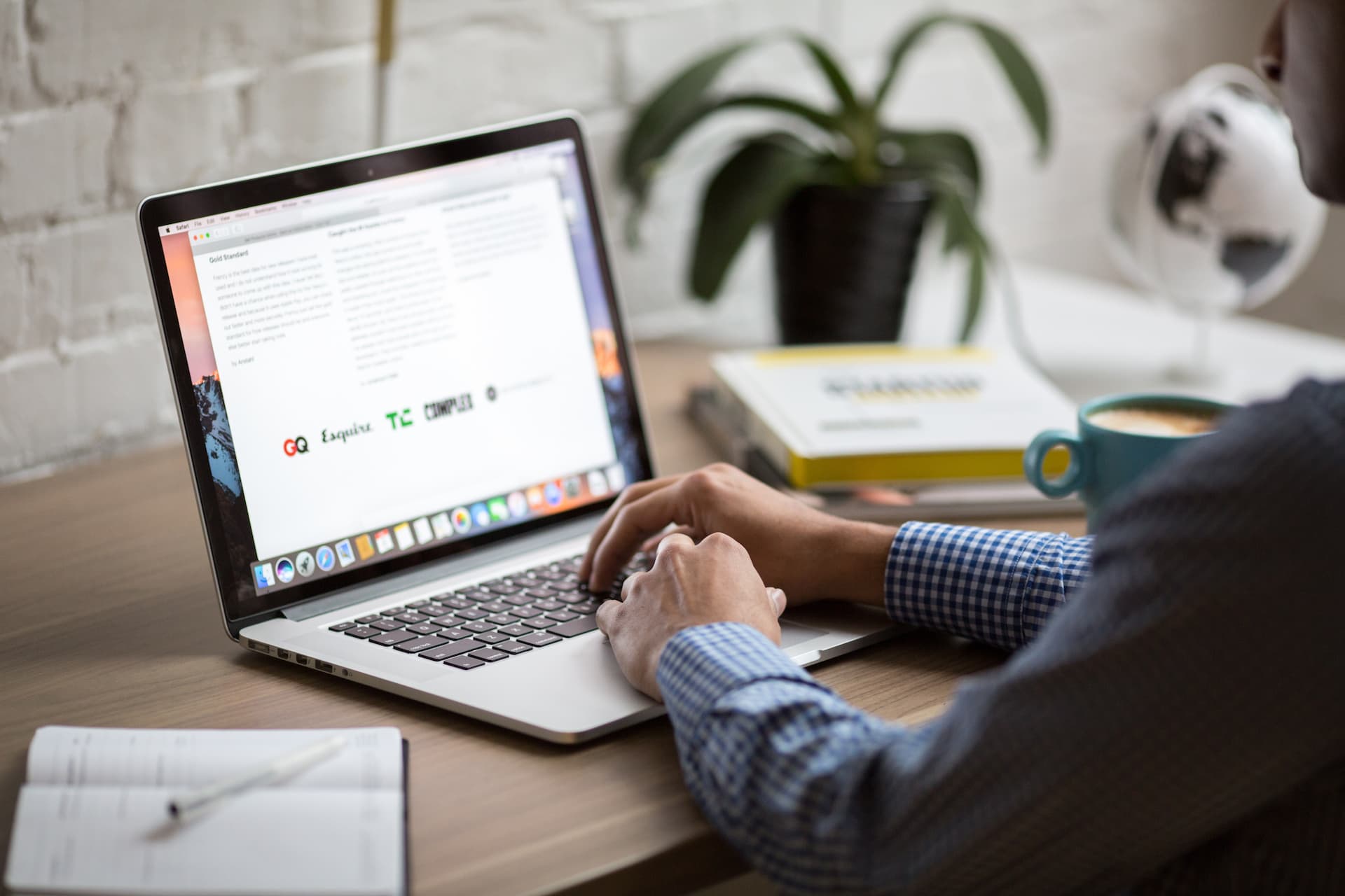 Person facing an open laptop on a table